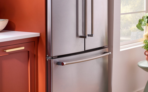 A KitchenAid® French door refrigerator next to terracotta cabinets